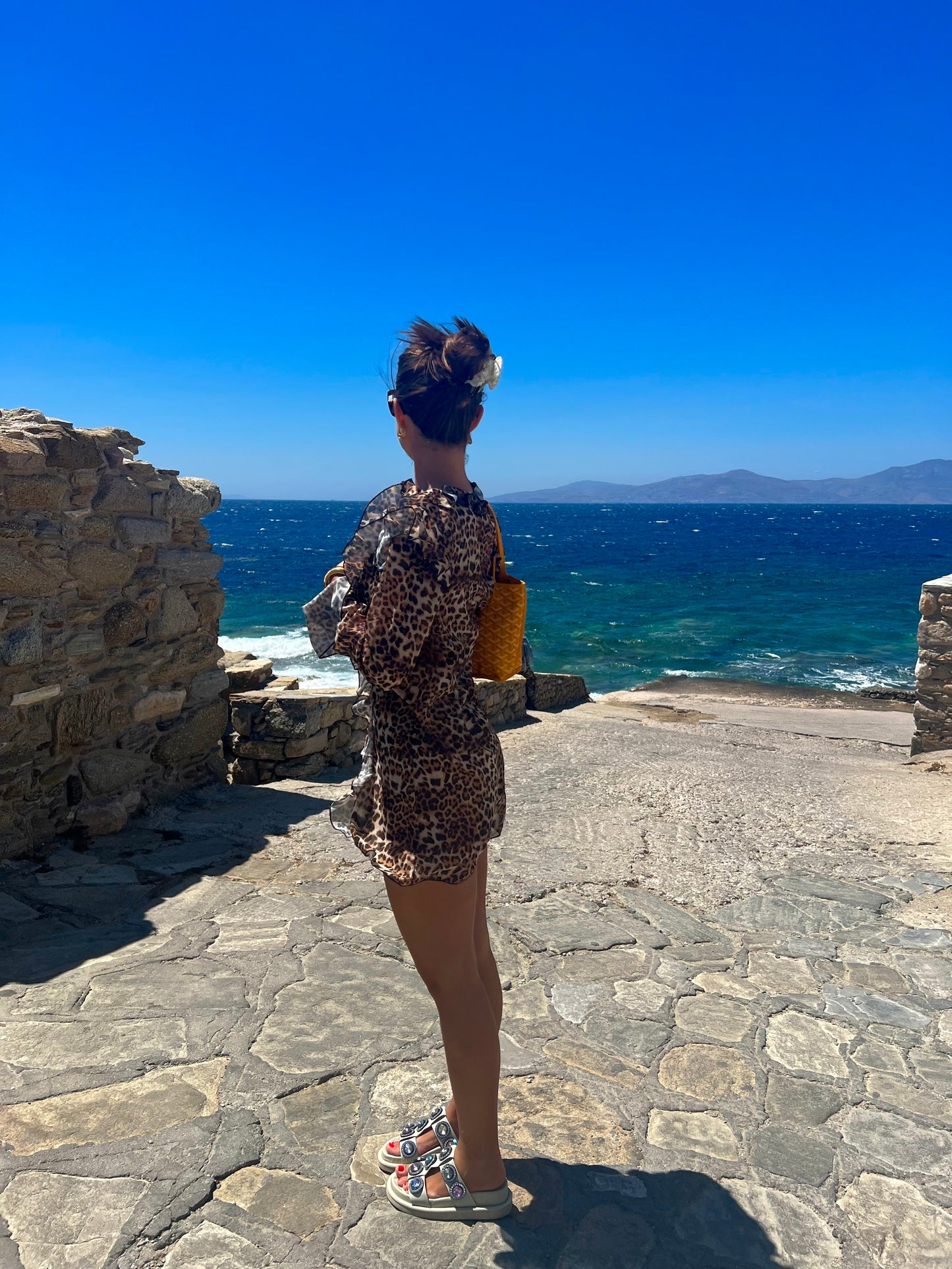 Make a bold statement with the Kit Kat Chiffon Dress, featuring a playful leopard print that exudes fierce femininity. The ruffled neckline adds a flirty touch, while the lightweight fabric ensures versatility as a stylish cover-up or a standout statement dress. Perfect for beach outings or casual gatherings, this dress combines wild charm with effortless elegance. Embrace your playful side and let the Kit Kat Chiffon Dress elevate your wardrobe with its vibrant personality and chic design!