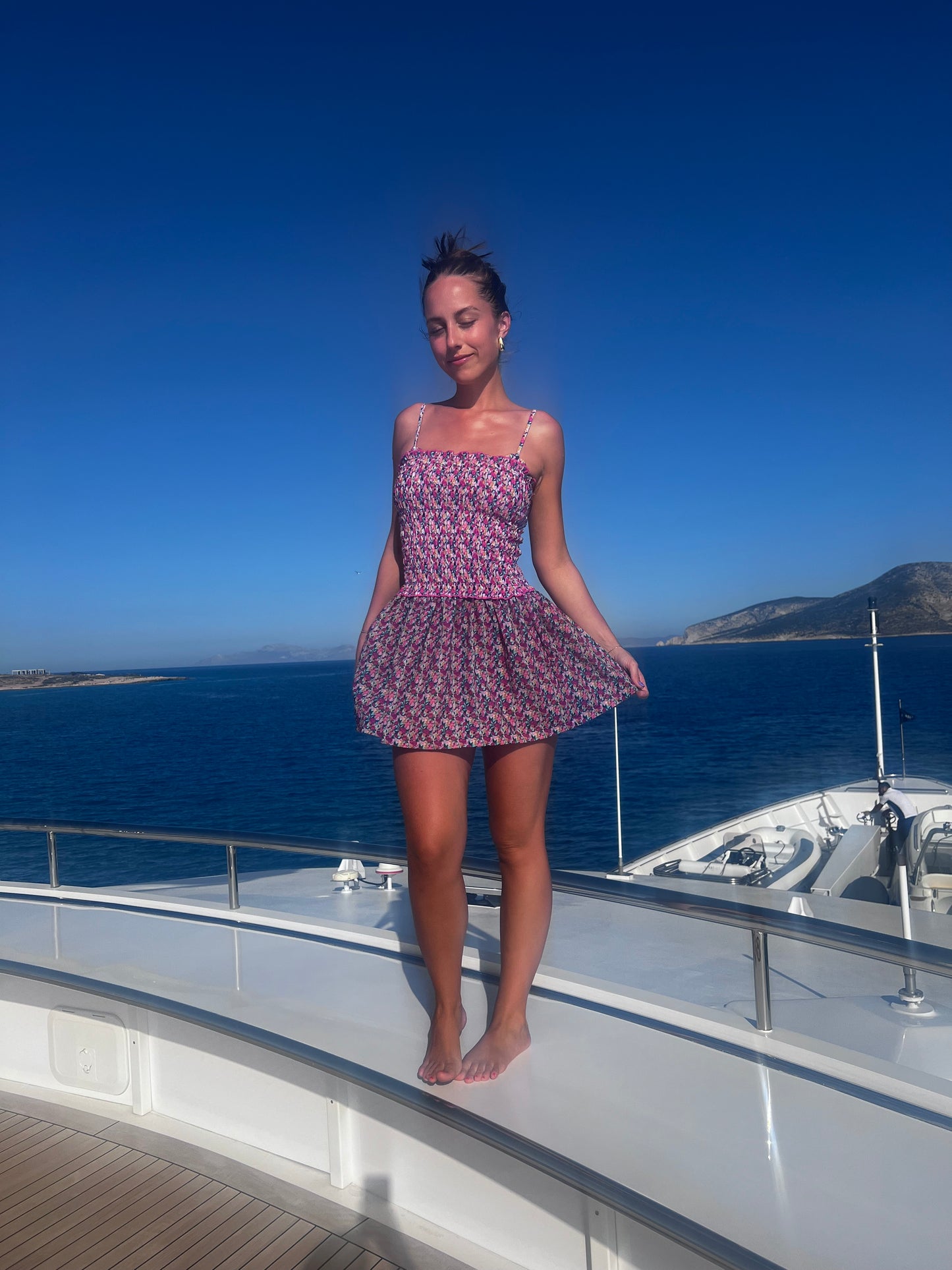 The Naxos Scrunch Dress is a stunning strapless mini dress that features a dreamy mix of purple, pink, and blue floral patterns. Designed with a flattering scrunch tube top, it accentuates your figure while providing comfort. The breezy flared skirt adds a playful touch, making this dress versatile for any occasion, from beach outings to casual gatherings. Effortlessly stylish, this dress combines elegance with ease, ensuring you look chic and feel fabulous all summer long!