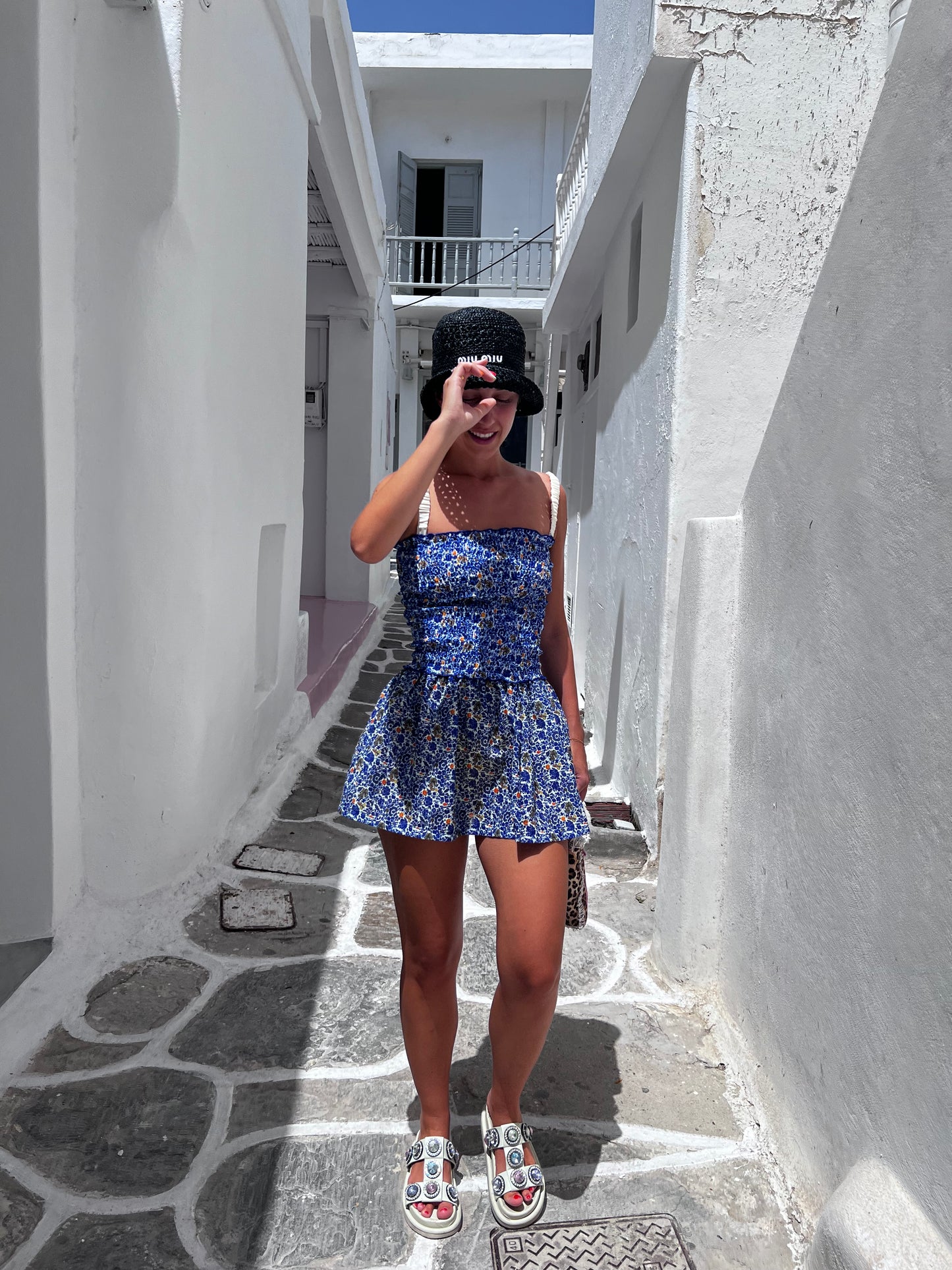 The Mykonos Scrunch Dress is a vibrant and versatile tube dress that captures the essence of Greek summer. Adorned with beautiful blue, white, and pops of yellow florals, this dress is perfect as a stylish cover-up or a chic outfit for sunny adventures. The soft scrunched material hugs your curves beautifully, while the lightweight, flowy skirt ensures comfort and movement. Embrace effortless elegance with this must-have piece that’s ideal for beach days and casual outings alike!
