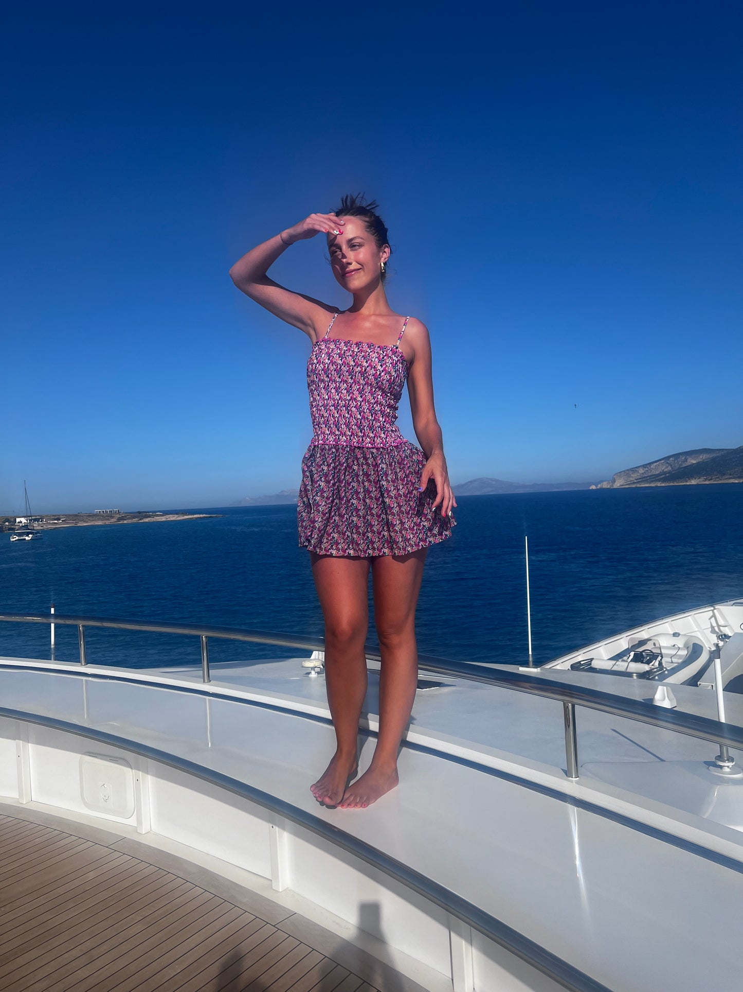 The Naxos Scrunch Dress is a stunning strapless mini dress that features a dreamy mix of purple, pink, and blue floral patterns. Designed with a flattering scrunch tube top, it accentuates your figure while providing comfort. The breezy flared skirt adds a playful touch, making this dress versatile for any occasion, from beach outings to casual gatherings. Effortlessly stylish, this dress combines elegance with ease, ensuring you look chic and feel fabulous all summer long!