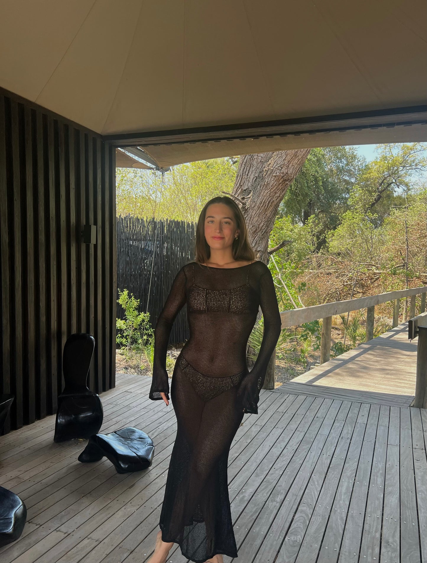 The Desert Lily Dress, an elegant black knit bikini cover-up that effortlessly combines style and comfort. This maxi dress features a thin, breathable mesh that gracefully molds to your body, accentuating your silhouette. With long sleeves for added sophistication, it provides a perfect balance of grace and confidence. Ideal for beach outings or casual gatherings, The Desert Lily Dress is designed to elevate your summer wardrobe while ensuring you feel chic and comfortable all day long!