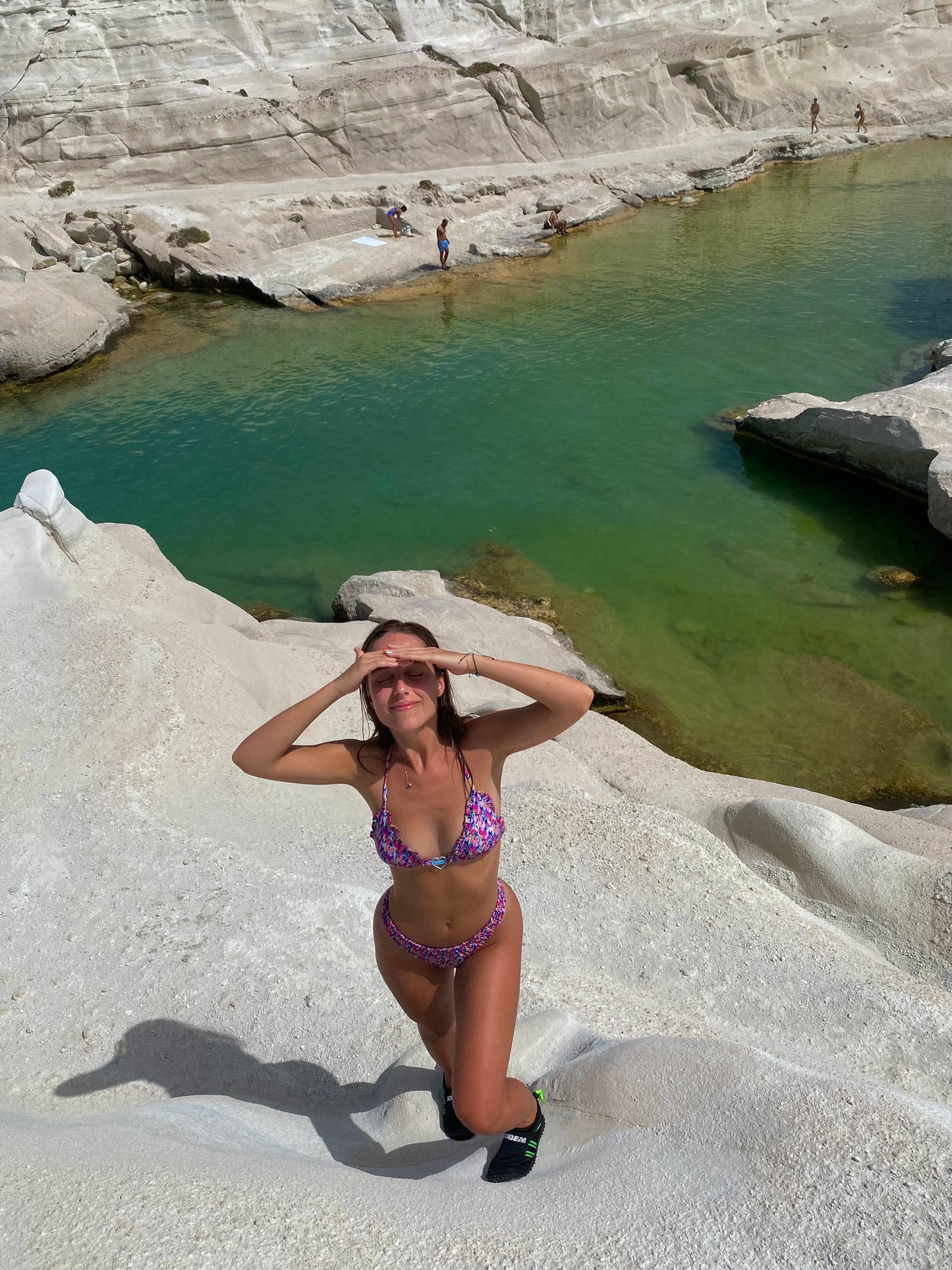 The Naxos Bikini, featuring a stunning floral print in vibrant purples, pinks, and blues. This bikini combines elegance and comfort, highlighted by a charming heart logo charm that adds a touch of sophistication. The unique scrunch detail enhances its flattering silhouette, ensuring you look and feel your best. Perfect for sun-soaked days by the beach or pool, this bikini captures the grace of island living while providing a stylish fit for every body type.