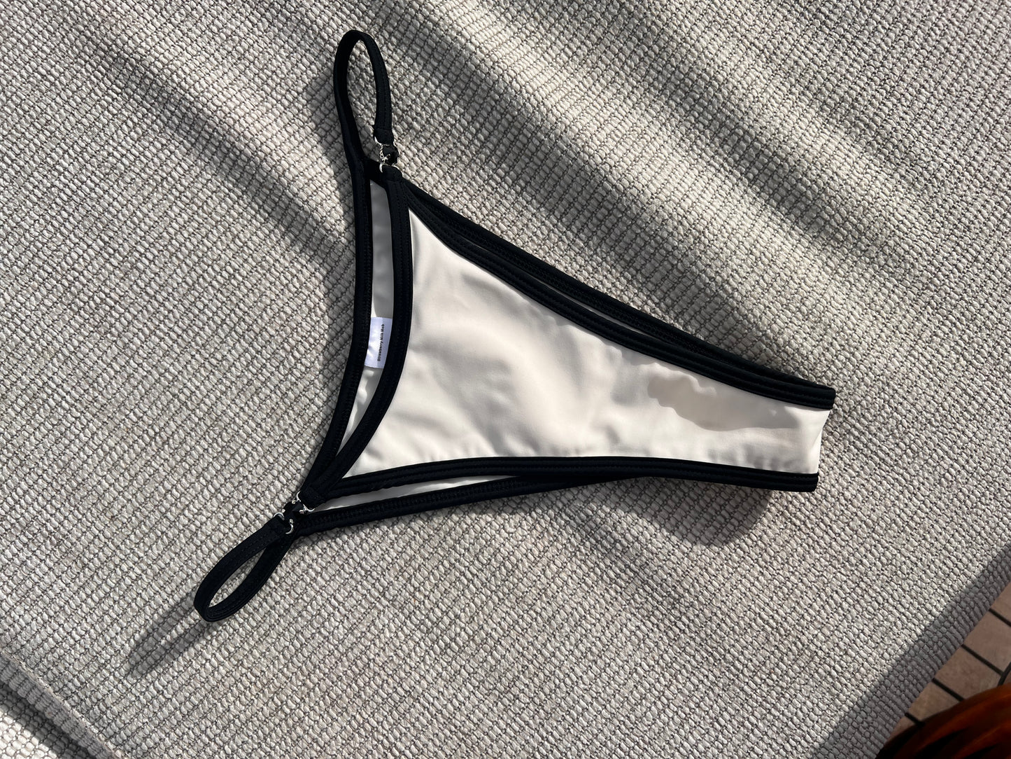 The Milos Bikini is a stunning blend of classic elegance and modern flair, featuring a monochrome palette of black and cream. This luxurious piece boasts sleek lines and exquisite black gem detailing, adding a touch of sophistication. Its design ensures a flattering fit that enhances your silhouette, making it perfect for any beach or poolside occasion. Elevate your swimwear collection with this timeless bikini that exudes confidence and style, effortlessly combining comfort with high-fashion appeal.