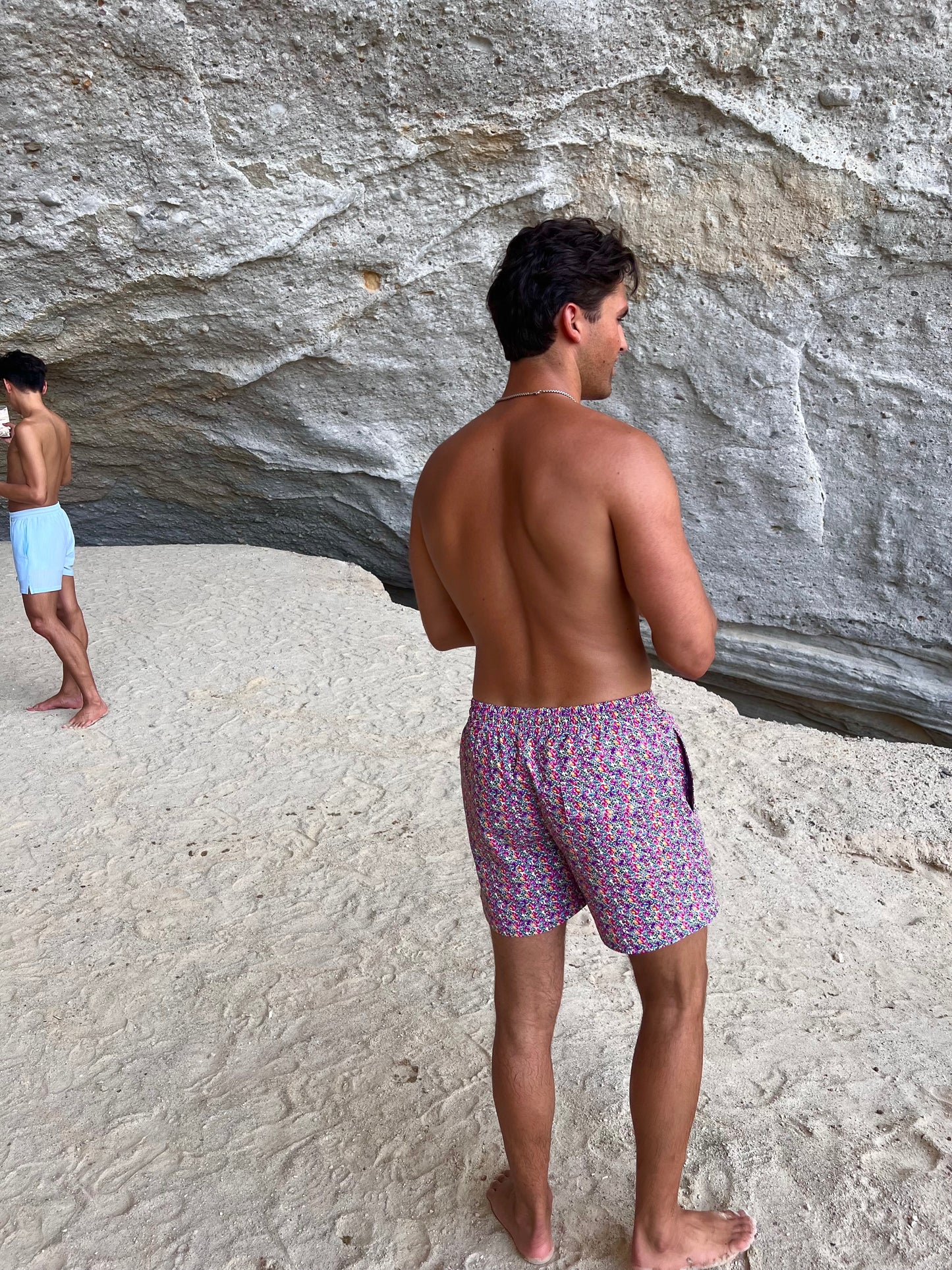 The Saint Tropez Short, the ultimate men's swim shorts that blend functionality and fashion. Featuring a vibrant floral print in purple and pink, these shorts embody effortless tropical vibes. Designed for comfort, they include a convenient string tie for a secure fit and functional pockets for your essentials. Versatile enough for beach days or pool parties, The Saint Tropez Short is a stylish choice that ensures you stand out while enjoying the sun!