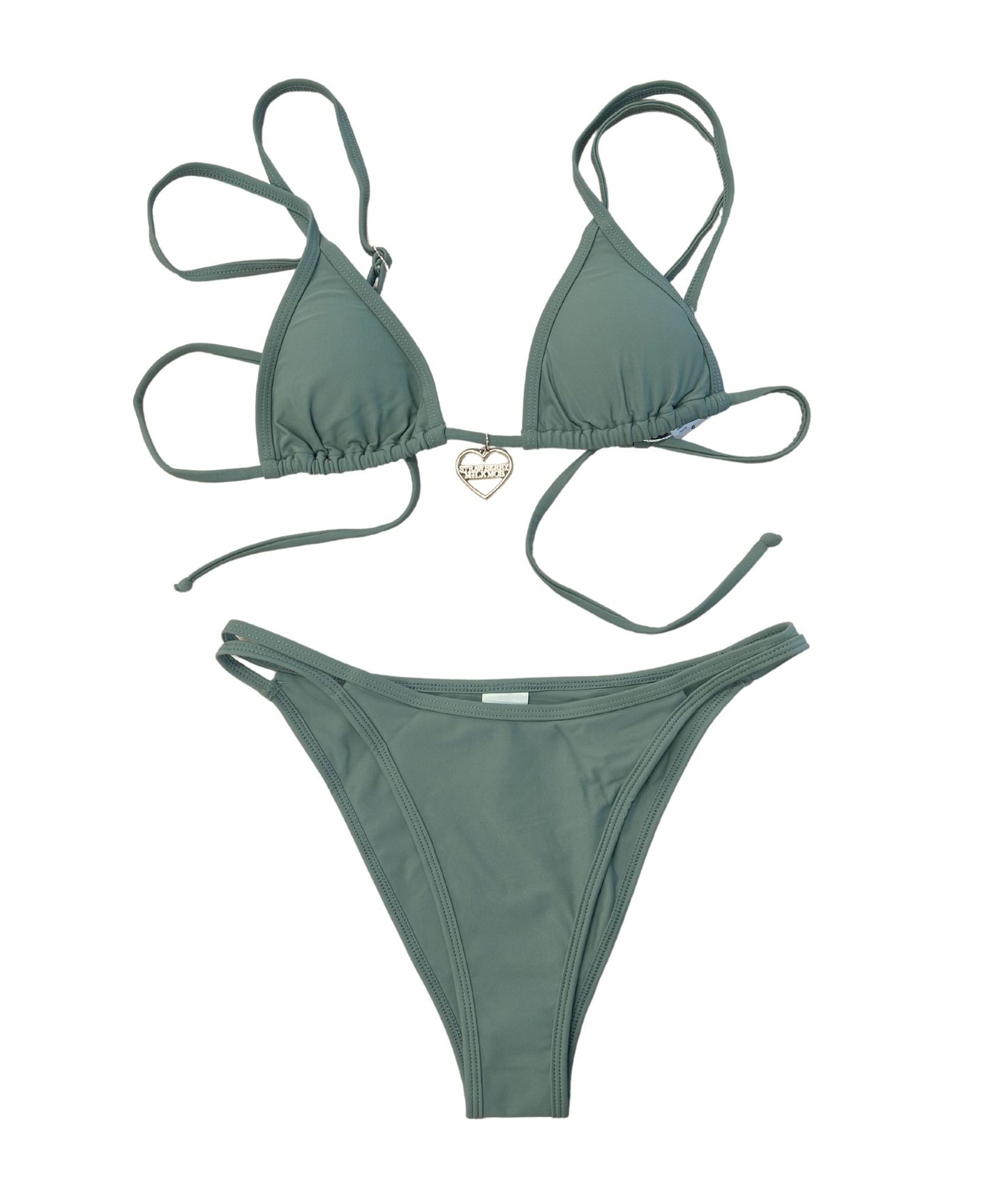 The Table Bikini, a gorgeous khaki green swimwear piece that embodies timeless, laid-back style. The triangle bikini top features a gold logo charm, adding a touch of sparkle to its classic fit. The strappy bottoms provide a confident and secure feel, making this bikini both stylish and versatile for any beach or pool day. Perfect for mixing and matching, The Table Bikini is designed to elevate your wardrobe while ensuring you look effortlessly chic!