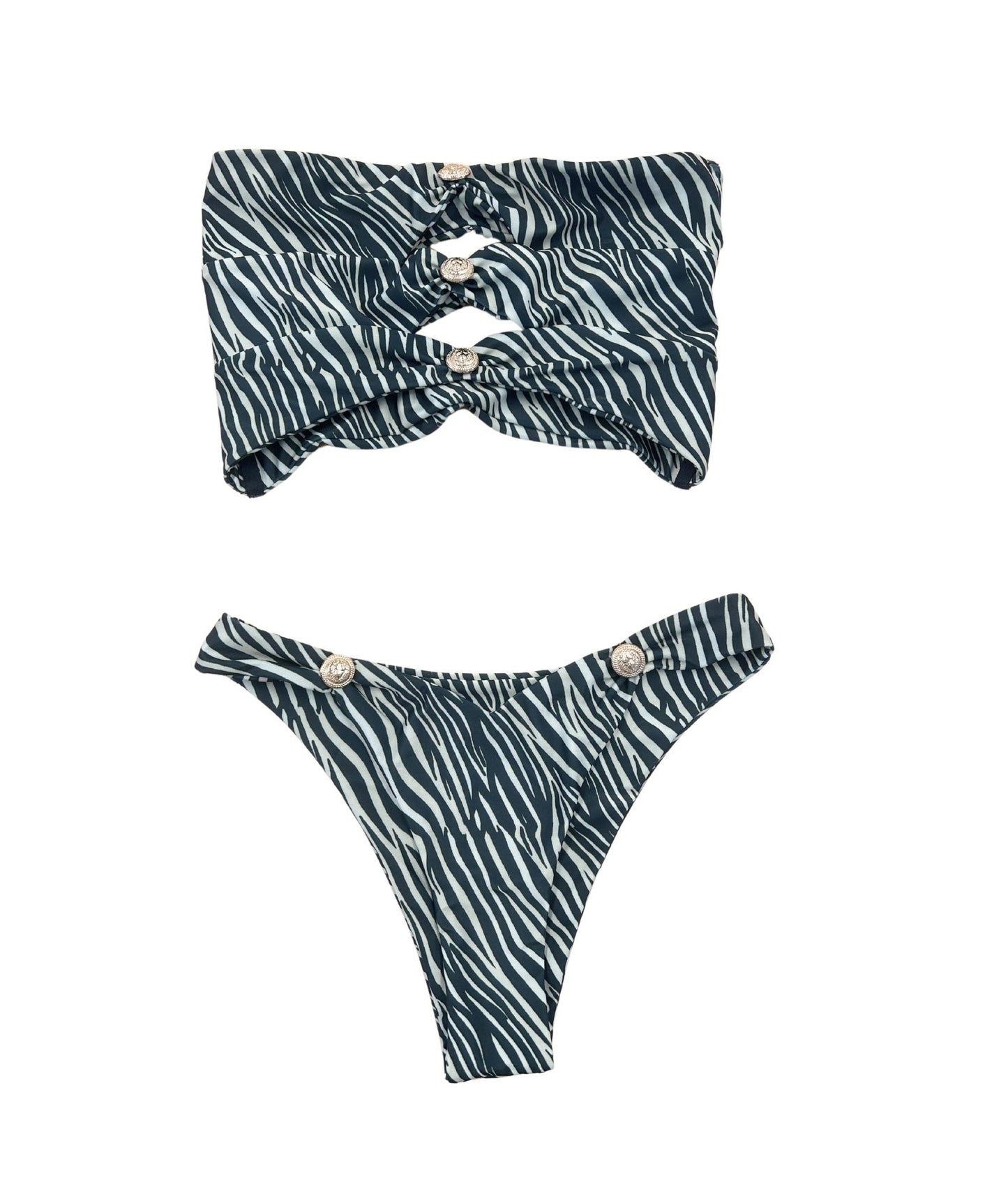 The Savute Bikini, a stunning swimwear piece featuring a bold zebra stripe pattern enhanced with luxurious gold hardware decals. The strapless bandeau top showcases stylish cut-outs, providing both support and a chic look. The cheeky bottoms are designed for comfort while ensuring you feel flirty and glamorous. Perfect for making a statement at the beach or pool, The Savute Bikini combines playful elegance with sleek design, making it an essential addition to your summer wardrobe!