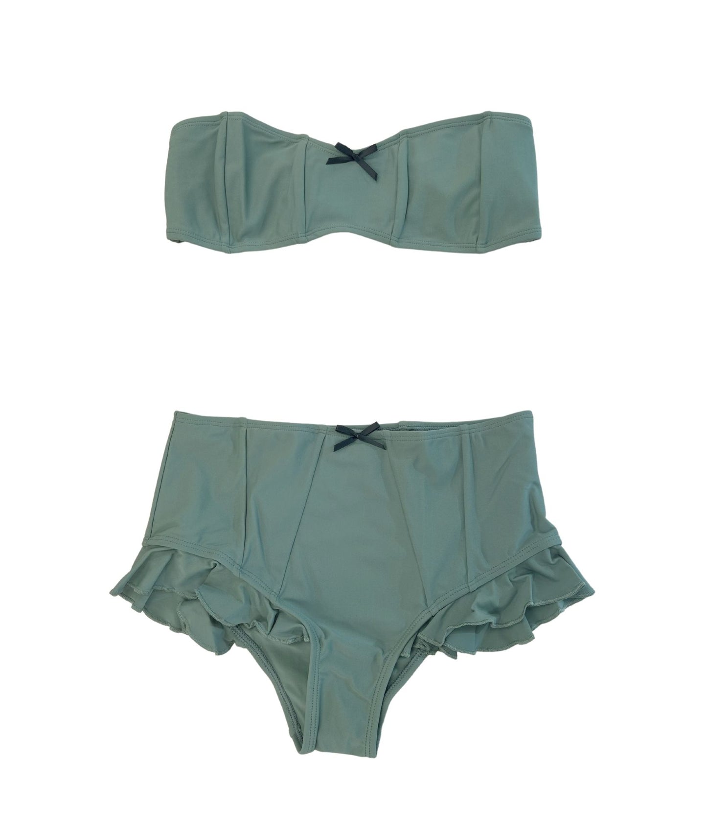 The Rosemary Bikini, a vintage-inspired swimwear piece with a modern twist. This beautiful sage green bikini features charming bow details that add a playful touch while remaining neutral and flattering. The bandeau top showcases a minimalist tie-back design for a comfortable fit, while the high-waisted bottoms feature elegant ruffle detailing, enhancing your silhouette. Versatile and stylish, the Rosemary Bikini is perfect for making a statement at the beach or pool!