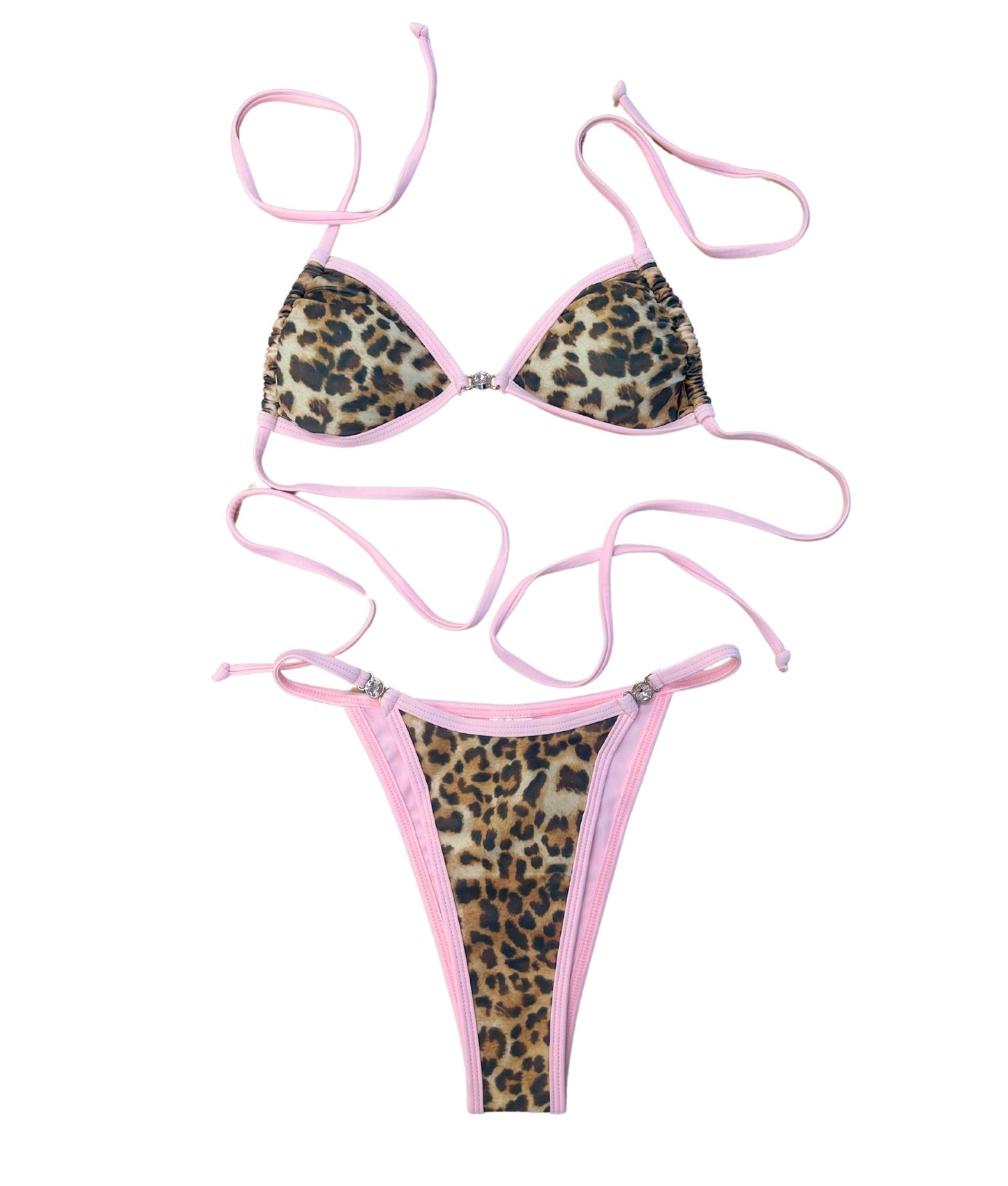 The Dash Bikini, a fierce and fabulous swimwear choice that combines bold style with sweet charm. This stunning design features a striking bronze and black leopard print complemented by a soft baby pink lining, creating an eye-catching contrast. The bikini is elevated with sparkling gem detailing, adding a touch of glamour to your beach look. Flirty and confident, The Dash Bikini is perfect for those who want to stand out and make a statement this summer!