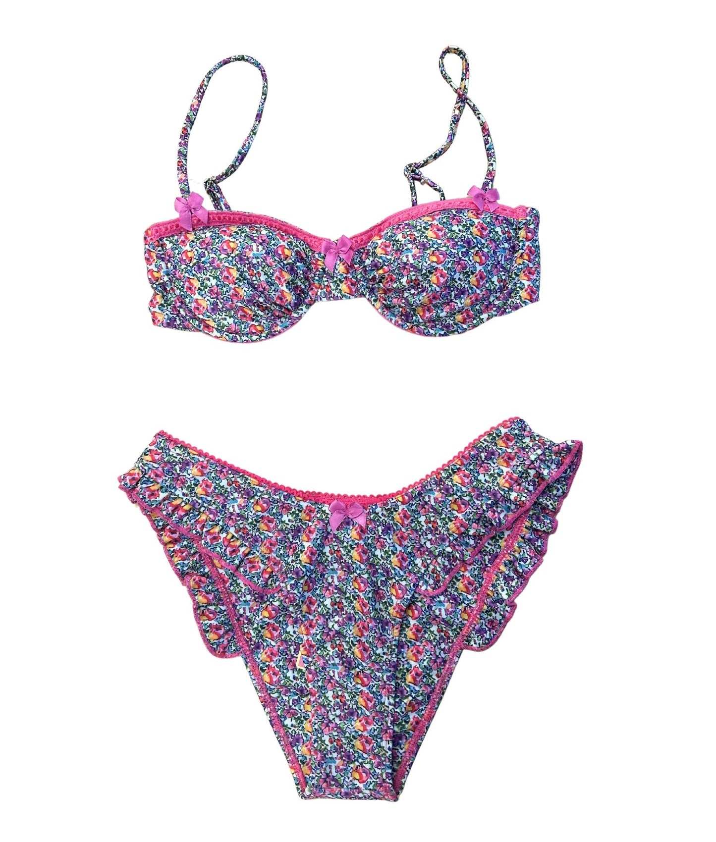 The Saint Tropez Bikini, where sweet style meets undeniable charm. This delightful bikini features dreamy pink and purple florals that pop against a fresh backdrop, creating a vibrant look perfect for summer. Accented with playful pink lace and bow details, it exudes confidence and chic appeal. Designed for comfort and cuteness, this bikini is ideal for beach days or poolside lounging. Embrace your playful side and make a statement with The Saint Tropez Bikini, your go-to for sunny adventures!