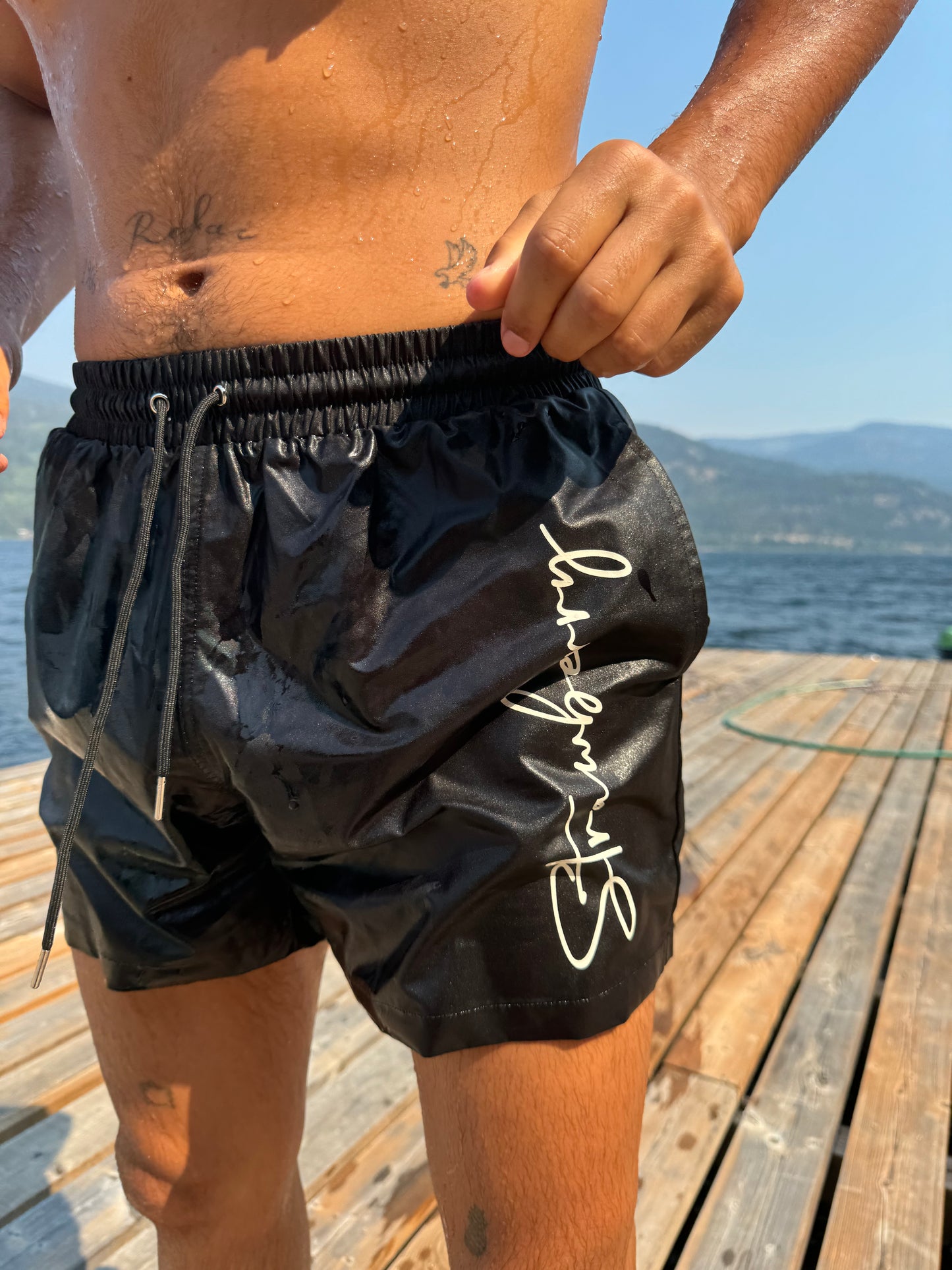 The Milos Short for men combines classic style with modern versatility, featuring a sleek black design accented by eye-catching cream 'Strawberry' detailing. These shorts are perfect for any occasion, whether you're lounging by the pool or heading out for a casual day. Crafted for comfort and style, they offer a relaxed fit that allows for easy movement. Elevate your wardrobe with these timeless shorts that effortlessly blend sophistication and practicality, making them a must-have for every man.