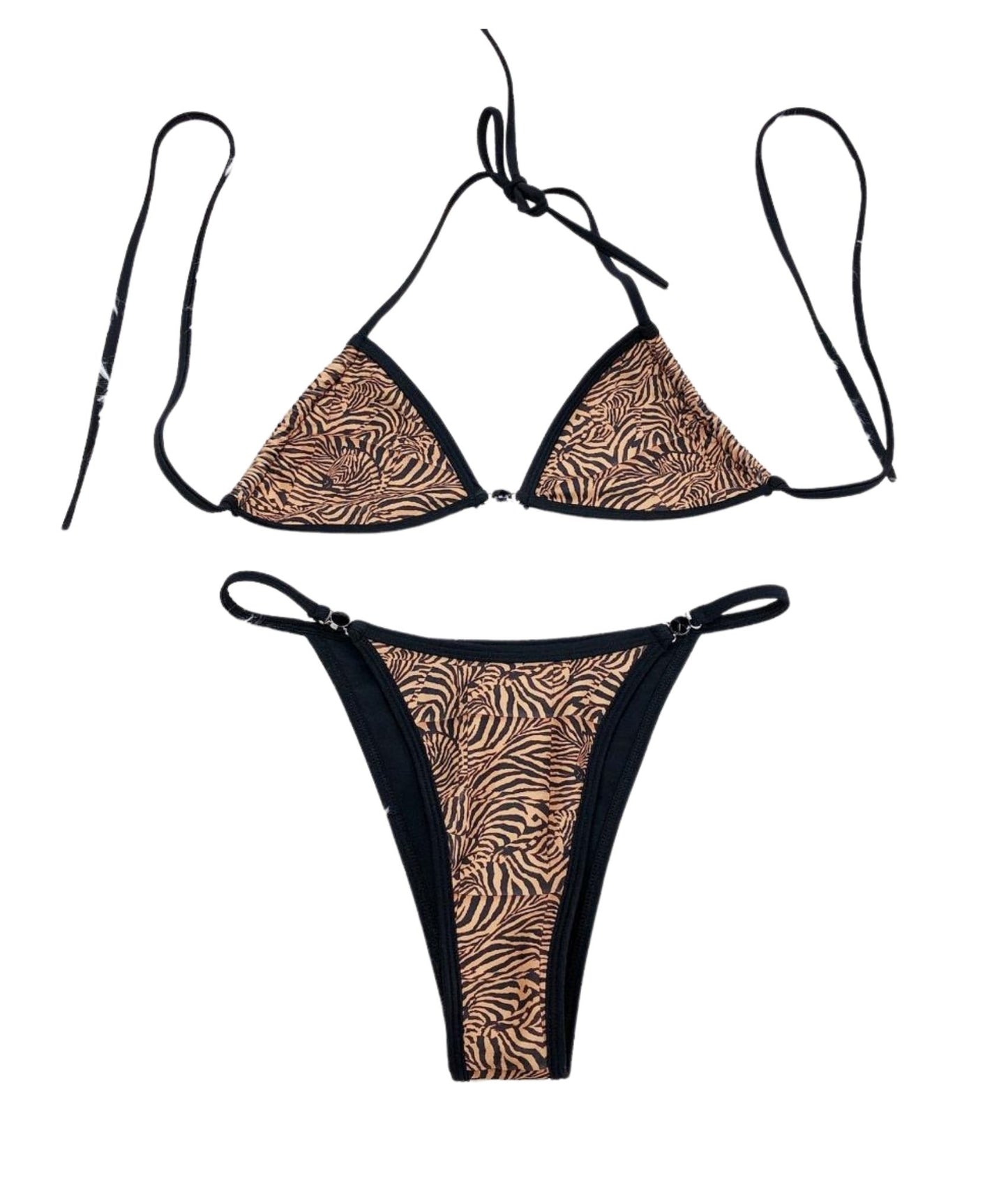 The Medusa Bikini, a fierce swimwear piece featuring a striking tiger stripe print that commands attention. With chic black lining and luxurious gemstone details, this bikini adds an elegant touch to your beach look. Designed for versatility and a flattering fit, it allows you to channel your inner tiger with confidence. Flirty and flawless, The Medusa Bikini is perfect for making a bold statement while enjoying the sun, ensuring you stand out wherever you go!