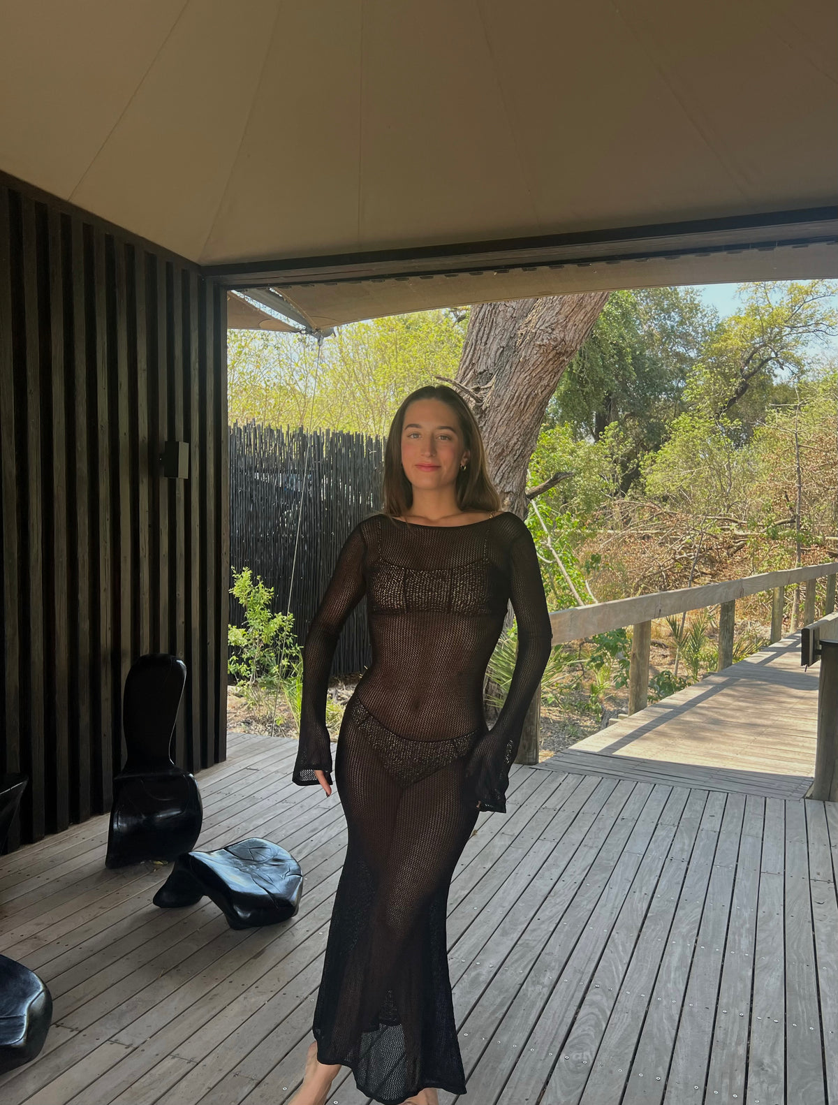 The Desert Lily Dress, an elegant black knit bikini cover-up that effortlessly combines style and comfort. This maxi dress features a thin, breathable mesh that gracefully molds to your body, accentuating your silhouette. With long sleeves for added sophistication, it provides a perfect balance of grace and confidence. Ideal for beach outings or casual gatherings, The Desert Lily Dress is designed to elevate your summer wardrobe while ensuring you feel chic and comfortable all day long!