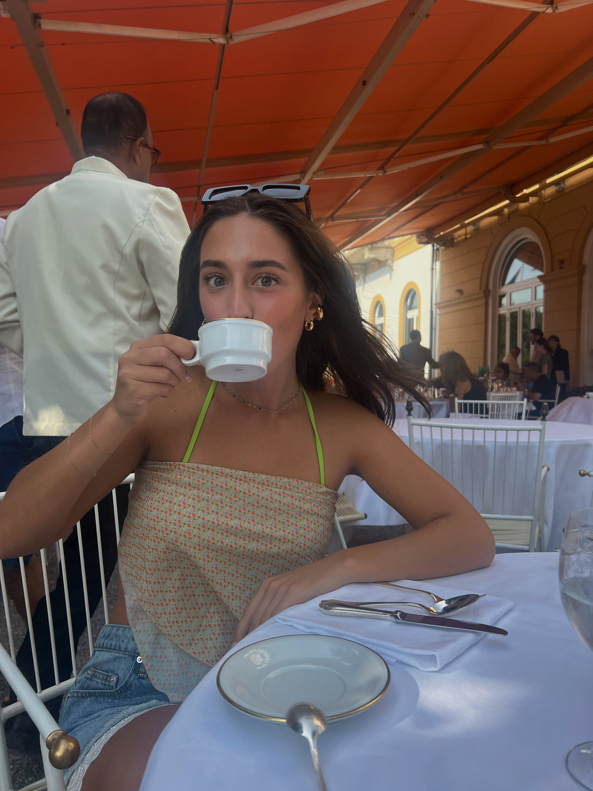 The Carousel Love Sarong, a beautifully designed cover-up that embodies elegance and romantic charm. Featuring a soft yellow and orange floral print, this sarong adds a flirty and feminine touch to your beach ensemble. Its versatile design allows for effortless styling—wear it as a head wrap, top, or skirt. Perfect for transitioning from sunbathing to seaside strolls, this sarong is your go-to accessory for showcasing effortless elegance all summer long!