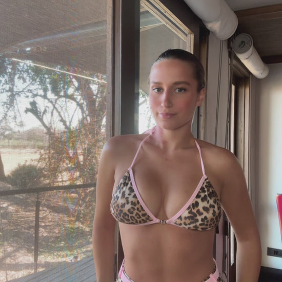 The Dash Bikini, a fierce and fabulous swimwear choice that combines bold style with sweet charm. This stunning design features a striking bronze and black leopard print complemented by a soft baby pink lining, creating an eye-catching contrast. The bikini is elevated with sparkling gem detailing, adding a touch of glamour to your beach look. Flirty and confident, The Dash Bikini is perfect for those who want to stand out and make a statement this summer!